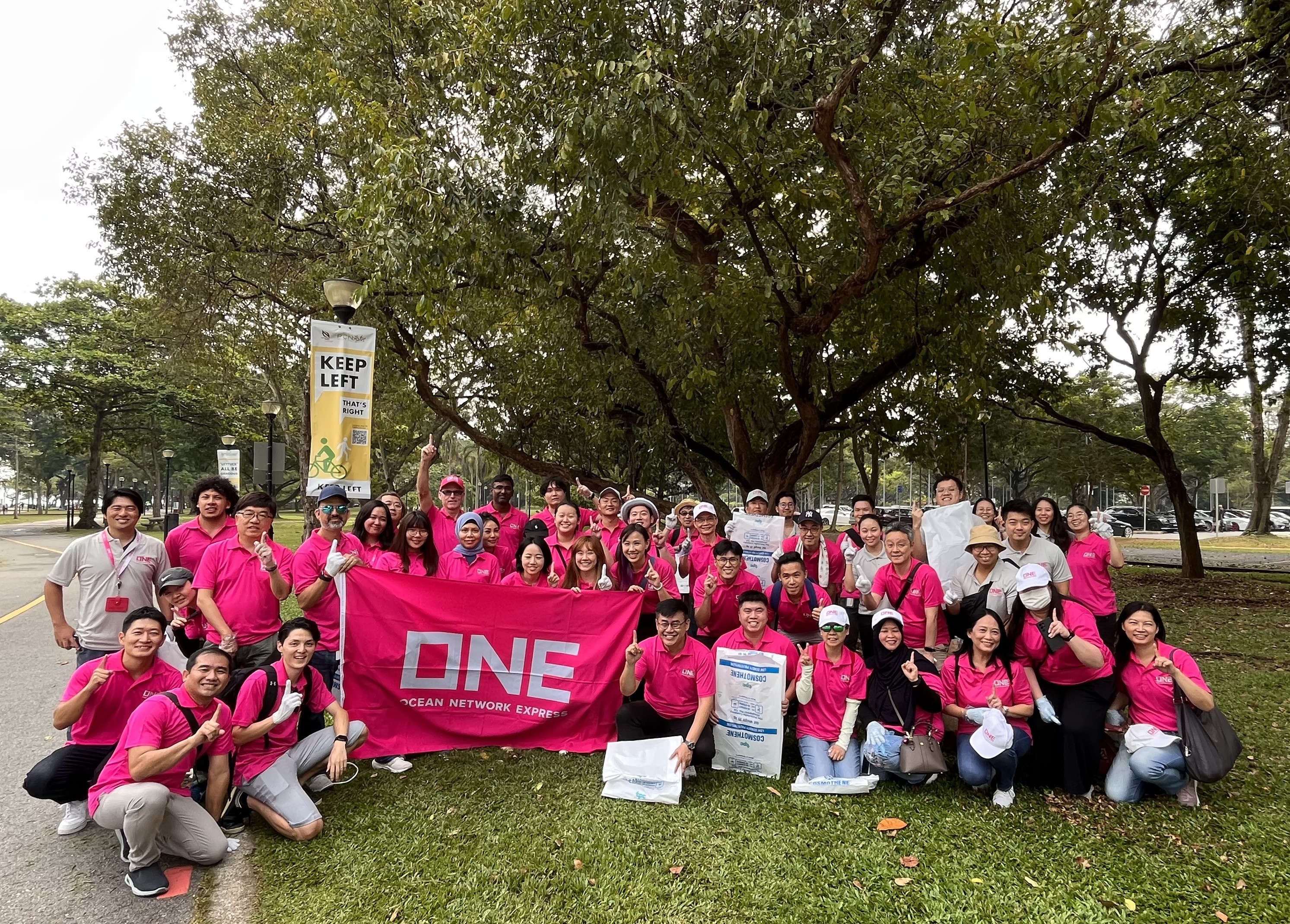 CEO Jeremy Nixon and MD Yasuki Iwai with ONE Volunteers in front of the Pink Mempat (cratoxylum formosum) Heritage Tree